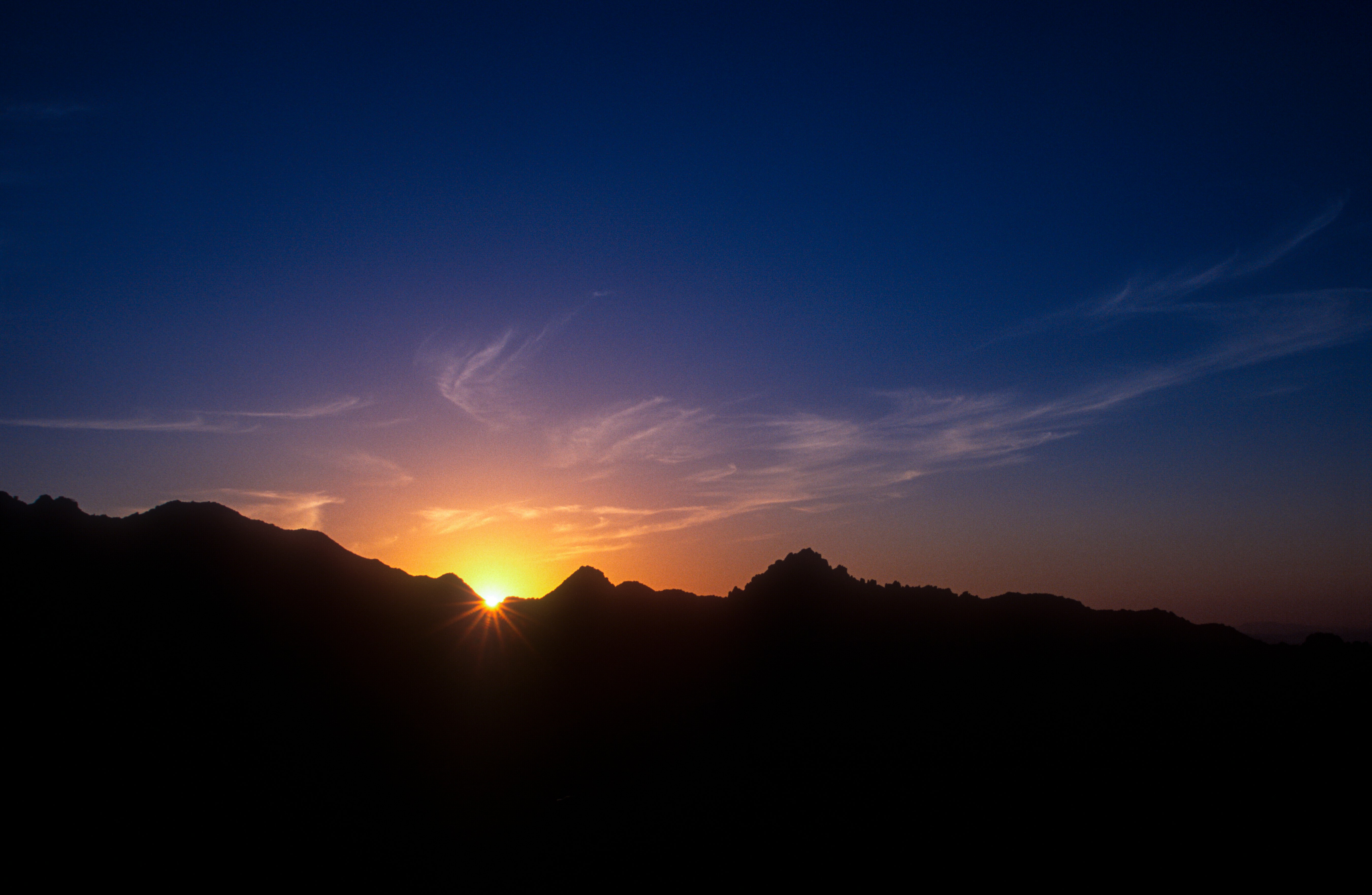 silhouette of mountain during sunset